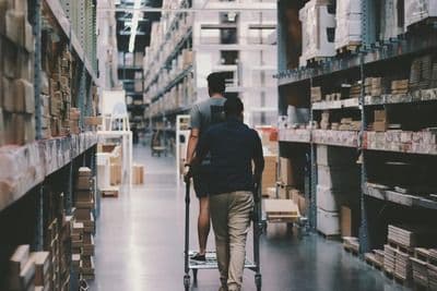 Two Men Walking in a Warehouse