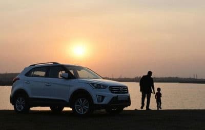 Car parked by a sunset