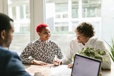 People sitting around a desk discussing life insurance